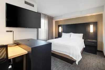 a hotel room with a bed and a desk at Residence Inn by Marriott Whitby in Whitby