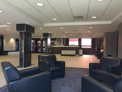 a waiting room with chairs and a reception desk at Residence & Conference Centre - Oakville in Oakville