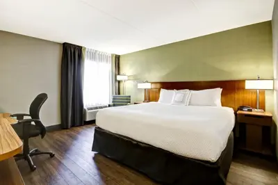 a hotel room with a large bed and a desk at Fairfield Inn & Suites by Marriott Guelph in Guelph