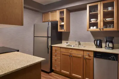 a kitchen with a refrigerator and a sink at Residence Inn by Marriott London Canada in London