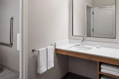 a bathroom with a sink and a mirror and towels at Residence Inn by Marriott Mississauga-Airport Corporate Centre West in Mississauga