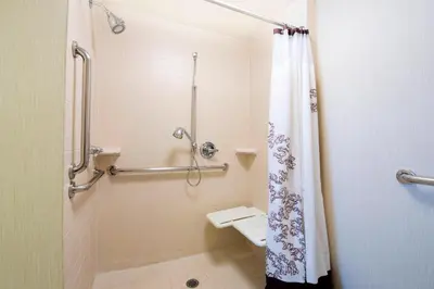a bathroom with a shower with a shower curtain at Residence Inn by Marriott Mississauga-Airport Corporate Centre West in Mississauga