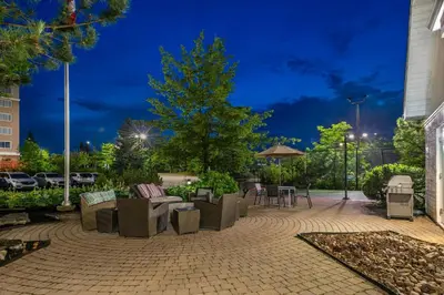 a patio with chairs and tables at night at Residence Inn by Marriott Toronto Markham in Markham