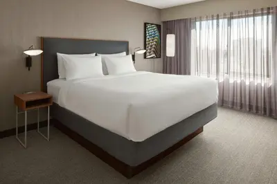 a bedroom with a large white bed and a window at Courtyard by Marriott Mississauga-Airport Corporate Centre West in Mississauga