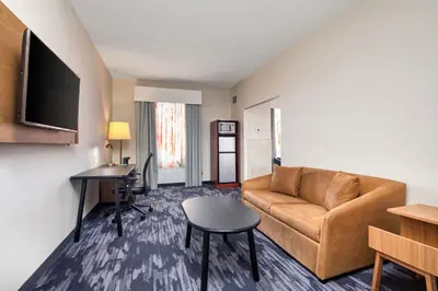 a living room with a couch and a table at Fairfield Inn by Marriott Toronto Oakville in Oakville