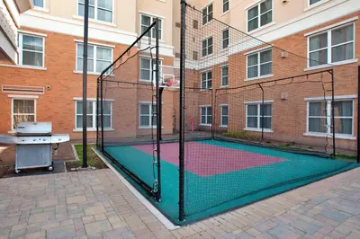 a tennis court with a net in front of a building at Residence Inn by Marriott Toronto Vaughan in Vaughan
