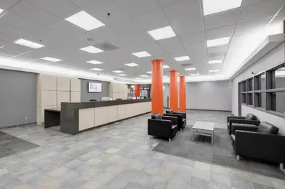 an office with a waiting room with chairs and a table at Residence & Conference Centre - Toronto in Toronto
