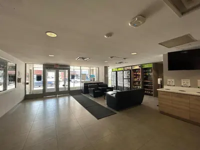 a living room with couches and a tv in a building at Residence & Conference Centre - Brampton in Brampton