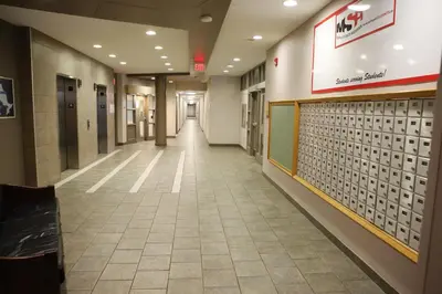 an empty hallway in a hospital with a hallwaygue at Residence & Conference Centre - Hamilton in Hamilton