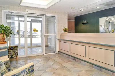 a lobby of a restaurant with a reception counter at Motel 6-Peterborough, ON in Peterborough