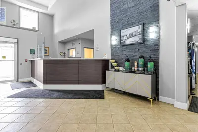 a large room with a counter and a brick wall at Quality Inn & Suites in Grimsby
