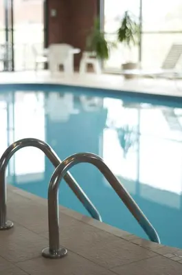 a chair sitting in front of a swimming pool at Visitor's Inn in Hamilton