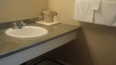 a bathroom with a sink and a towel at Port Motel in Port Colborne