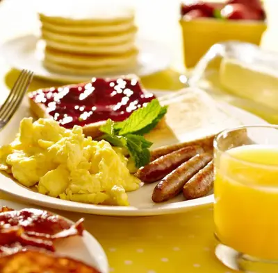 a plate of breakfast food with sausage and toast at Susan's Villa in Niagara Falls