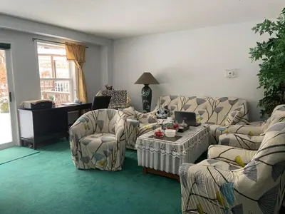 a living room with couches and a table and chairs at Susan's Villa in Niagara Falls
