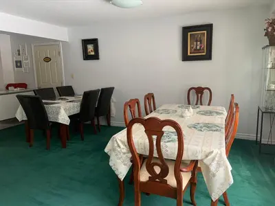 a dining room with two tables and chairs and a table and chairsktop at Susan's Villa in Niagara Falls