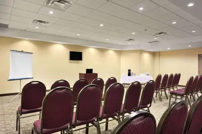 a conference room with a table and chairs and a podium at Days Inn by Wyndham Brampton in Brampton