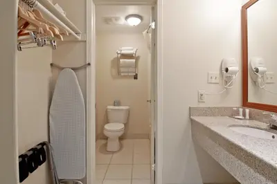 a bathroom with a toilet and a sink at Travelodge by Wyndham Trenton in Trenton