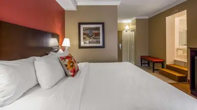 a large white bed in a hotel room at Best Western Plus Bowmanville in Bowmanville