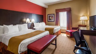 a hotel room with two beds and a television at Best Western Plus Bowmanville in Bowmanville