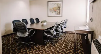 a meeting room with a table and chairs at Best Western Plus Bowmanville in Bowmanville