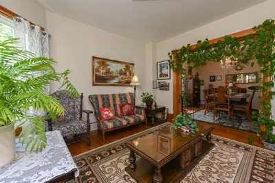 a living room filled with furniture and a table at Niagara Inn Bed and Breakfast in Niagara Falls