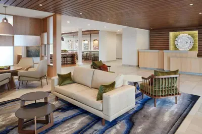 a living room with a couch and a table at Fairfield by Marriott Inn & Suites Newmarket in Newmarket