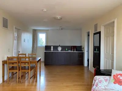 a kitchen and dining room with a table and chairs at Dairy Homestay in Toronto