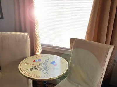 a plate sitting on top of a table next to two chairs at Butler Creek House in Niagara on the Lake