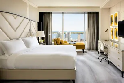 a hotel room with a bed and a large window at The Ritz-Carlton, Toronto in Toronto