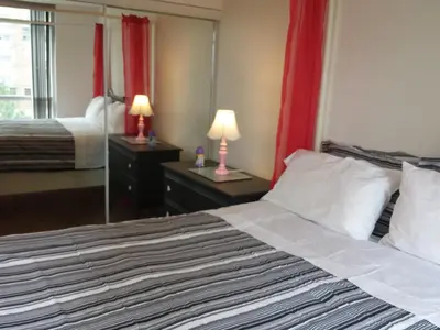 a hotel room with a bed and a mirror at 2 Bedroom 1 Bathroom Prime Location in Mississauga in Mississauga