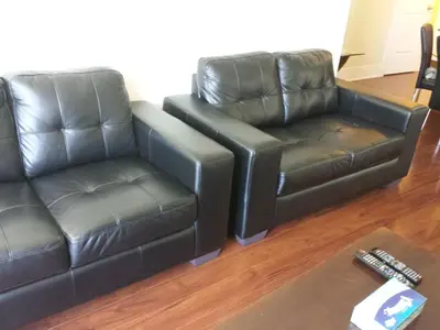 two leather chairs and a couch in a living room at 2 BEDROOM 2 Bathroom Best Value Prime Location in Missisauga in Mississauga