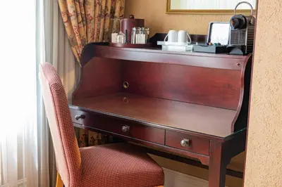 a wooden desk with a chair in a hotel room at Old Mill Toronto Hotel in Toronto