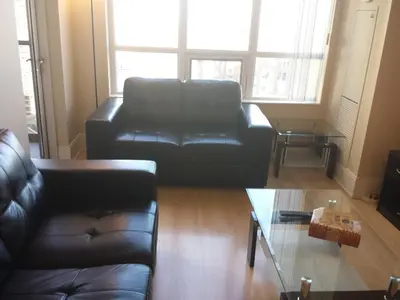 a living room with a leather couch and a coffee table at BEST LOCATION/SPECTACULAR VIEW 2 BEDROOMS FURNISHED CONDO S/L RENT in Mississauga
