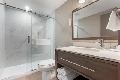 a bathroom with a shower and a toilet and a sink at Comfort Inn in Bracebridge
