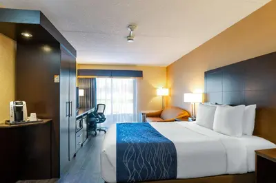 a hotel room with a large bed and a desk at Comfort Inn in Saint Thomas