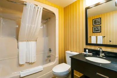 a bathroom with a toilet and a sink and a shower at Comfort Inn in Saint Thomas