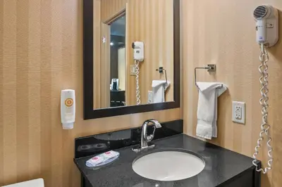 a bathroom with a sink and a mirror at Comfort Inn in Saint Thomas