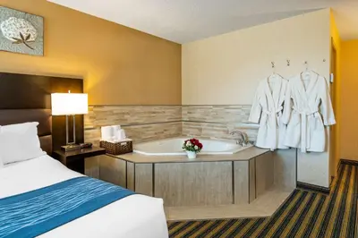 a hotel room with a bed and a bath tub at Comfort Inn in Saint Thomas