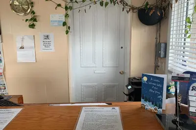 a room with a white door and a wooden table at Lucien Motel in Whitby