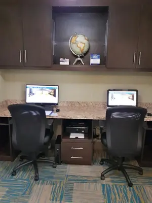 an office with two monitors on a desk with two chairs at Best Western Plus Durham Hotel & Conference Centre in Oshawa