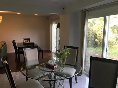 a dining room with a glass table and chairs at Home Base in Markham