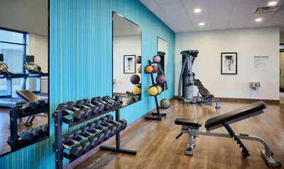 a gym with several tread machines and a mirror at Holiday Inn Express Niagara-On-The-Lake by IHG in Niagara on the Lake