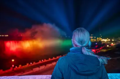 a woman looking at a city at night at Holiday Inn Express Niagara-On-The-Lake by IHG in Niagara on the Lake