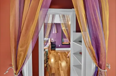 a room with purple walls and curtains at Globetrotters B&B in Niagara on the Lake