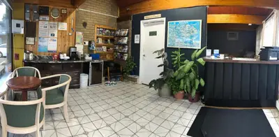a restaurant with a counter and a table and chairs at Advance Inn in Niagara Falls