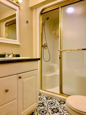 a bathroom with a shower and a toilet at WeatherPine Inn in Niagara on the Lake
