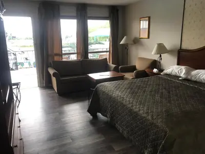 a hotel room with a bed and a couch at Rainbow Motor Inn - Fallsview in Niagara Falls