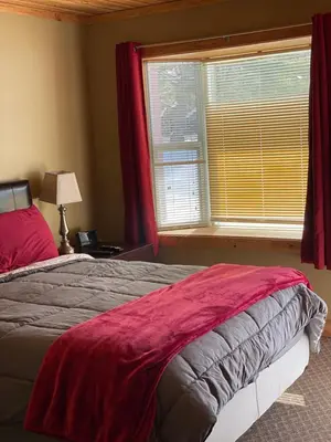 a bedroom with a large bed and a window at Noble Motel in Norland