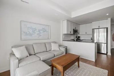 a living room with a couch and a kitchen at Touchstone Resort in Bracebridge